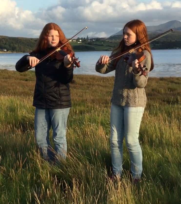 Gingersnaps playing outdoors beside a Loch in Scotland